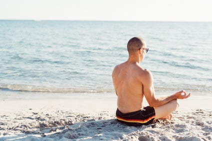 graphicstock-young-man-doing-yoga-on-the-beach-meditation-relaxing-zen-concept_Hp0CccY1--1024x683