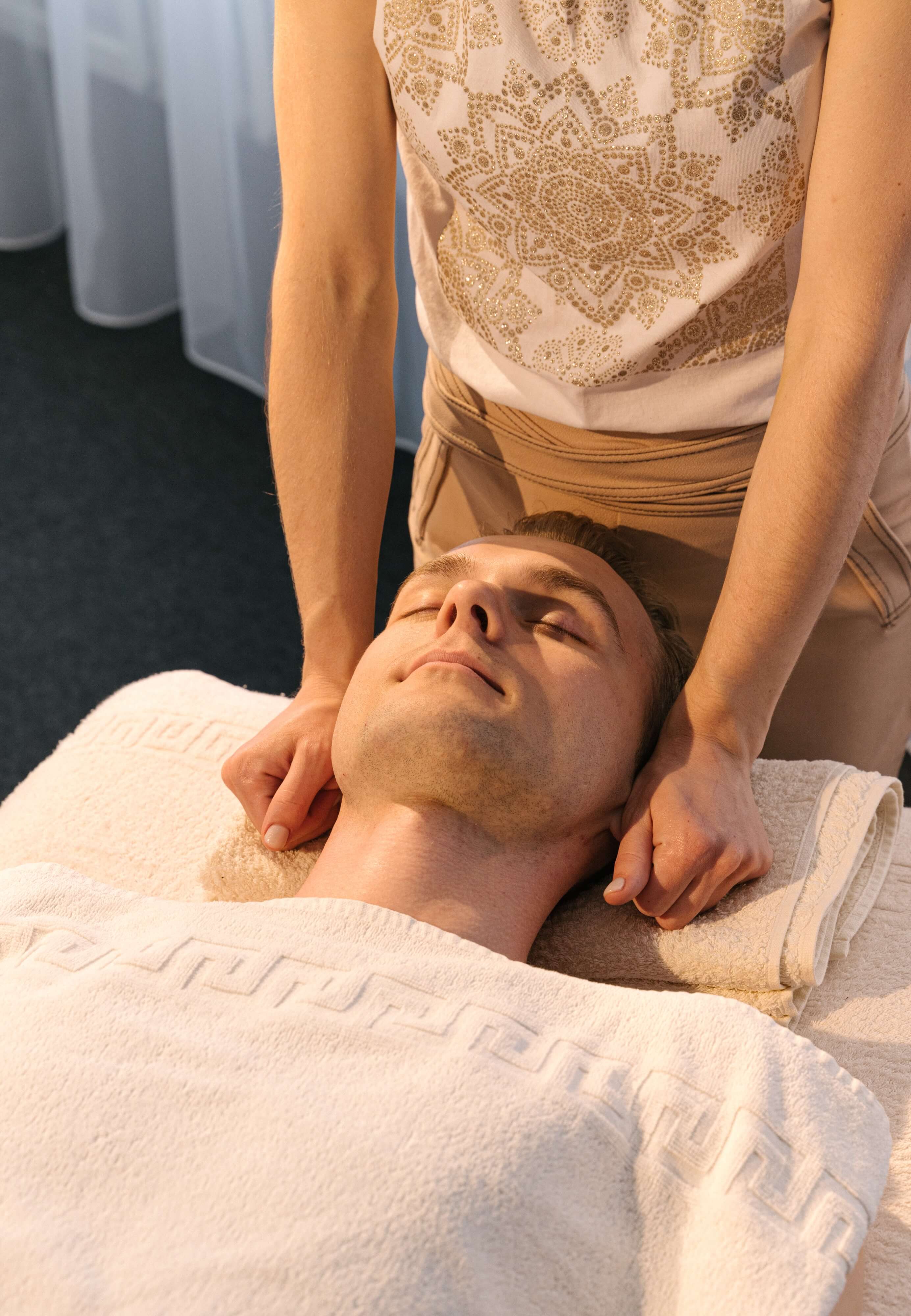 Man receiving massage on ears