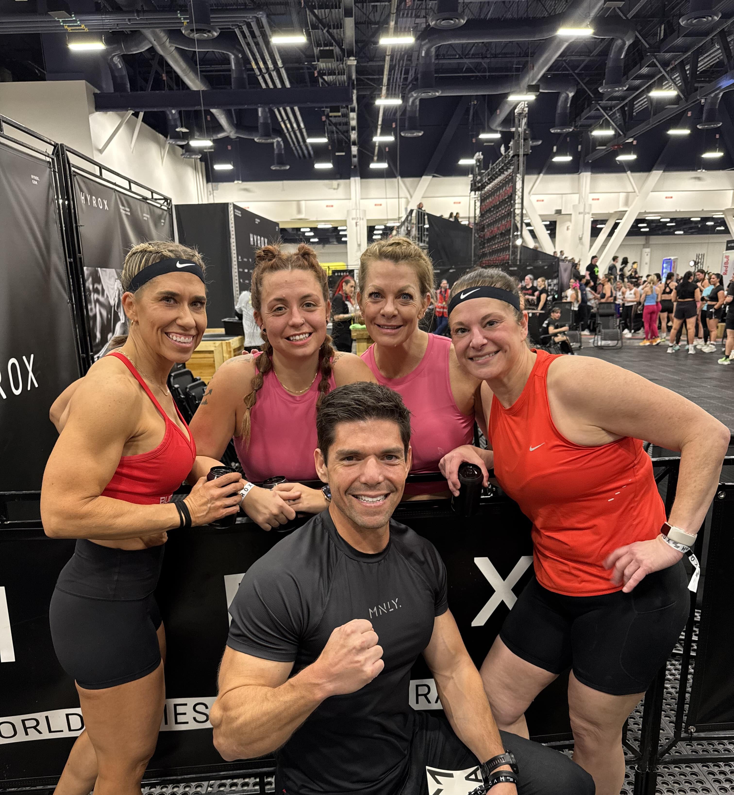group image of coach with 4 female athletes