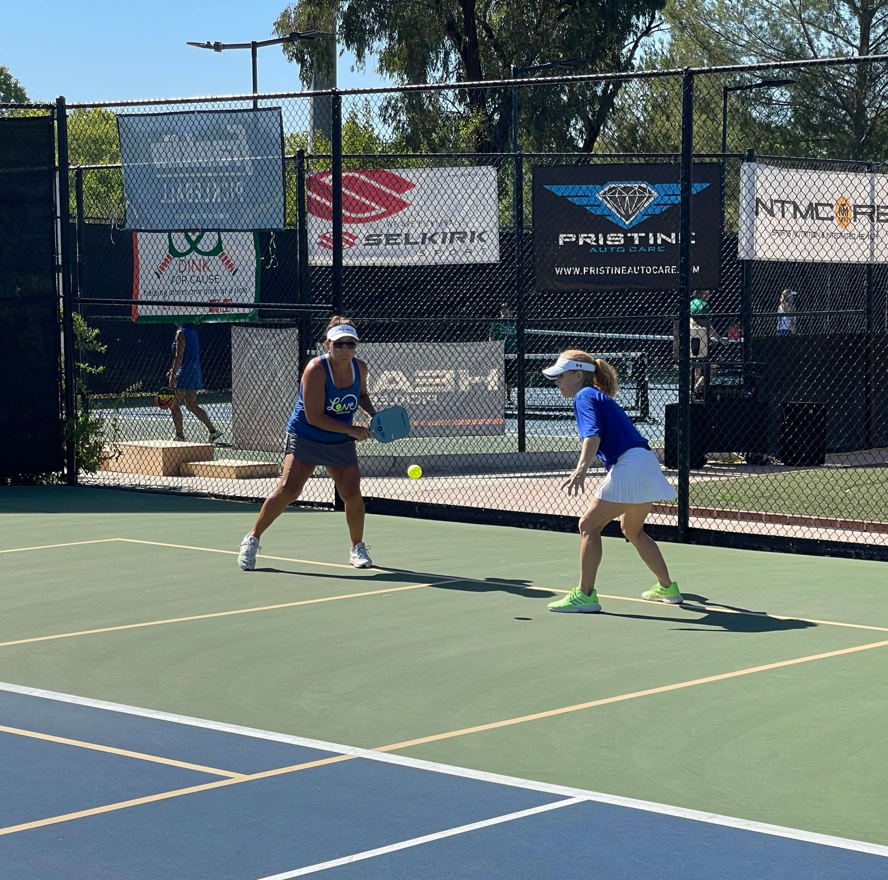 Two people playing pickleball