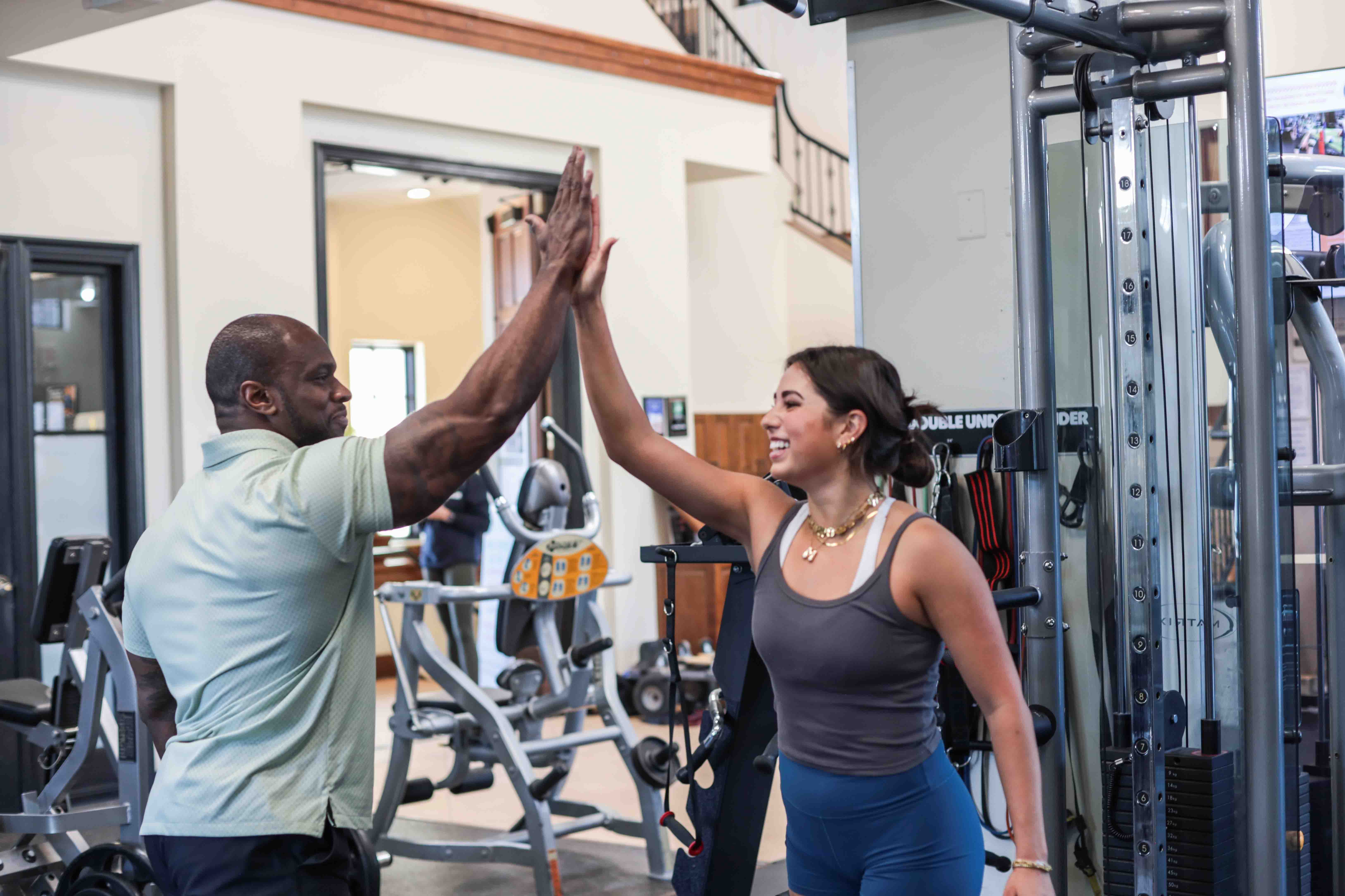 trainer and member high five