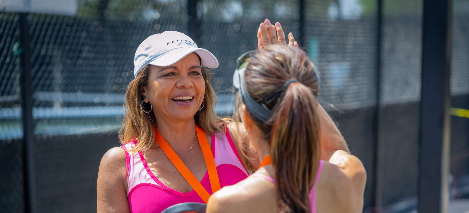 two women celebrating at pickleball